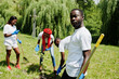 © AS Photo Family - Group of happy african volunteers planting tree in park. Africa volunteering, charity, people and ecology concept.