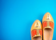 Traditional dutch wooden clogs isolated on blue background with copy space for your own text just for holiday or postcard etc