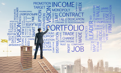 Young businessman standing on house roof and writing leadership