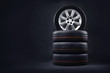 New tires pile on a dark background. Tire fitting background. Copy space.