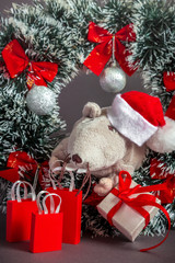 Christmas card symbol of the year 2020 a rat in a Santa hat looks out of a Christmas wreath on a gray background