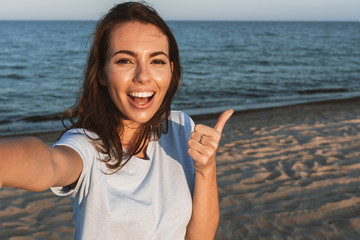 Wall Mural - Beautiful young woman having a lovely time at the beach