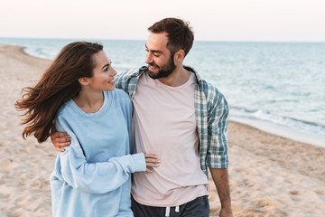 Wall Mural - beautiful young smiling couple spending time at the beach