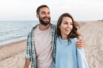 Canvas Print - Beautiful young smiling couple spending time at the beach