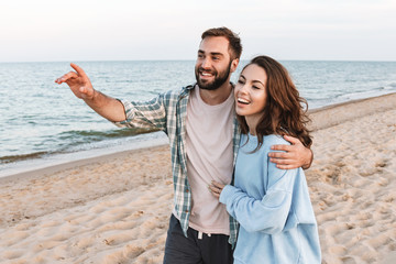 Wall Mural - beautiful young smiling couple spending time at the beach