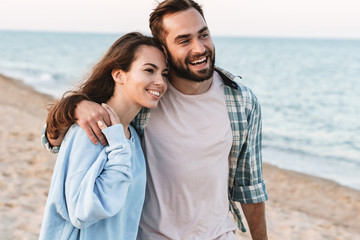 Wall Mural - beautiful young smiling couple spending time at the beach