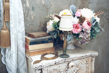 Vintage Room In A Photo Studio With A Vintage Wooden Table With Flowers, Vintage Mirrow And Books. Elements Of Vintage Style
