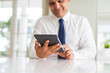 © Krakenimages.com - Close up of middle age business man using tablet