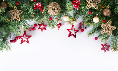 Poster - Festive Christmas border, isolated on white background. Fir green branches are decorated with gold stars, fir cones and red berries. Close-up, copy space.