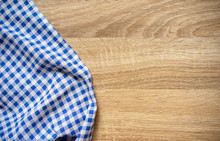Close Up Top View Blue Color Checked Pattern Fabric Tablecloth On Vintage Wood Texture Tabletop In Kitchen Background With Sepia Tone For Design  Concept