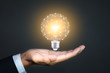 © Worawut - Innovative, solution and new idea concepts with Light bulb in hand of businessman