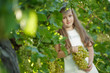 © nuzza11 - Child with grapes on nature.