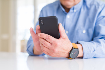 Poster - Close up of man hands using smartphone over white table