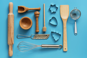 A variety of kitchen utensils for cooking on a blue background, mockup. Flat lay,overhead.