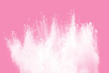 White powder explosion on pink background. White dust splash cloud on pink background.