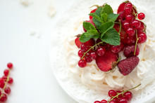 Pavlova Fruit Cake With Strawberry, Raspberry, Red Currant And Mint Leaves On White Background. Selective Focus. Healthy Food Concept