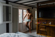 © Manuel Ruiz Alba/ADDICTIVE STOCK - Side view of young pensive sexy handsome male in underwear standing near terrace at home and looking away