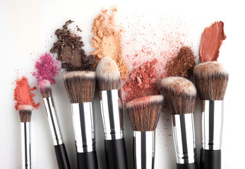 creative concept beauty fashion photo of cosmetic product make up brushes kit with smashed lipstick 