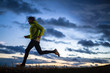 © Tandem Stock - A male runner wearing a headlamp running at dusk in north Idaho.