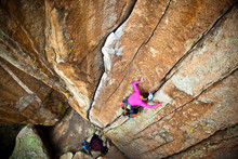 Woman Climbing On Rock