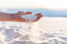 White Sands Dunes National Monument Hand Holding Sand Falling Grains In New Mexico At Sunset
