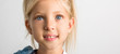 © yakovlevadaria - Beautiful blond girl of seven years old, big blue eyes, close-up, white background