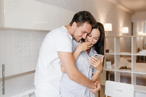 Romantic Man With Short Hairstyle Embracing Laughing Brunette Lady