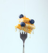 © Lidia Servellon/ADDICTIVE STOCK - Composition of sweet dessert with strawberry and blueberries flavored by honey on white background