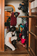 © Sonia Almudevar/ADDICTIVE STOCK - Side view of women in closet with staff getting dressed for horse riding