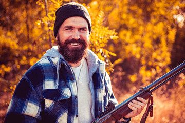 Wall Mural - Closed and open hunting season. Hunter with shotgun gun on hunt. Close up Portrait of hamdsome Hunter.