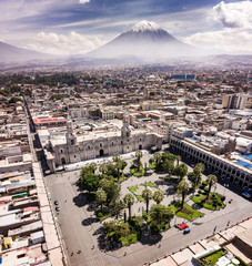 Canvas Print - Aerial drone view of Arequipa main square and cathedral church, with the Misti volcano as background.