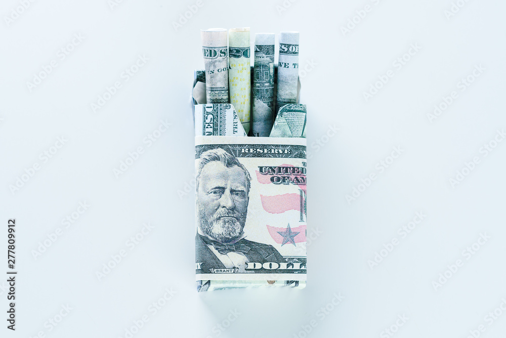 Package of cigarette filled with paper money dollars banknote instead of  cigarette sticks. Concept Smoking is actually burning or wasting money .  Stock Photo