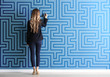 © Pixel-Shot - Woman in formal clothes drawing on color wall. Concept of business plan development