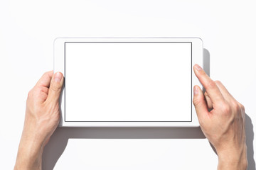 Aufkleber - Closeup of hands touching white tablet computer on white background with shadow. Blank screen. Top view.