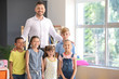 © Pixel-Shot - Male teacher with children in primary school