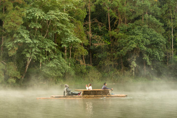 Wall Mural - mae hong son, thailand - december 23rd, 2017: people take bamboo raft for explore the river in fores