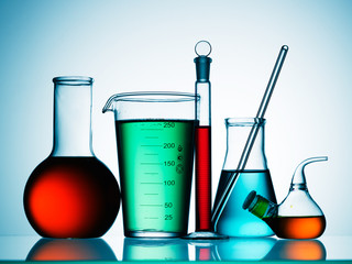 Wall Mural - different laboratory glassware with color liquid and with reflection