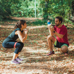 Wall Mural - Young Couple Exercising with Elastic Resistance Bands