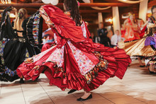Gypsy Dance Festival, Woman Performing Romany Dance And Folk Songs In National Clothing. Beautiful Roma Gypsy Girls Dancing In Traditional Floral Dress At Wedding Reception In Restaurant