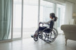 Woman on wheelchair looking outside