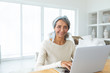 © wavebreak3 - Woman using white laptop on a table.
