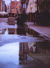  Reflection of buildings in a puddle after rain