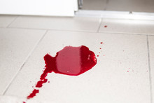 A Violence Conceptual Background Which Shows Blood Drops And Splash Is Scary And Dirty. A Puddle Of Dried Blood On The Tiled Bathroom Floor.