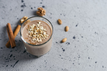 Wall Mural - Chocolate milk smoothie with oatmeal and nuts. Place for text