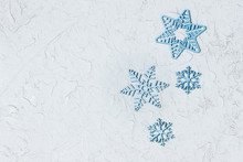 Christmas Sale Poster With Blue Snowflakes On Light Background With Copy Space. Carved Snowflakes From Wood. Flat Lay. Top View.