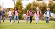 © Monkey Business - Excited Elementary School Pupils Running Across Field At Break Time