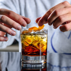 Sticker - bartender prepares a classic Negroni cocktail