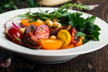 Veggie chickpeas salad with fresh vegetables and herbs, plant based meal