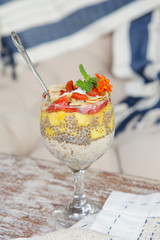 Wall Mural - Chia pudding with strawberry, mango and sliced almonds, healthy delicious breakfast option