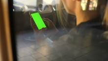 Close Up Woman Hands Use Smartphone In Vintage Car On Parking Green Screen Chroma Scroll Social Media Shopping 5g